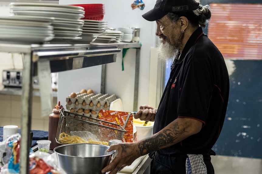 A chef cooking hot chips.  