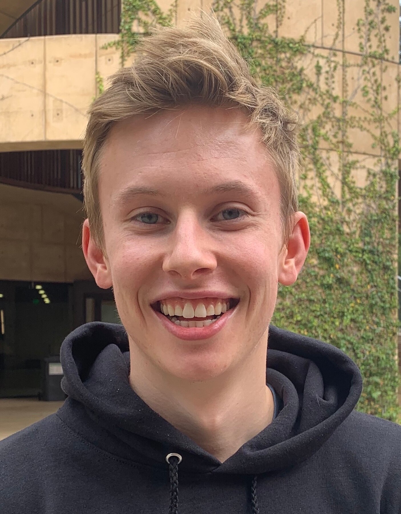 Close up of man with blond hair and wide smile 