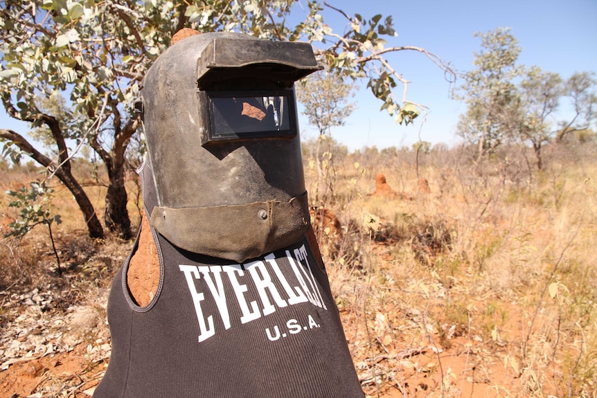 A termite mound wearing a welding mask