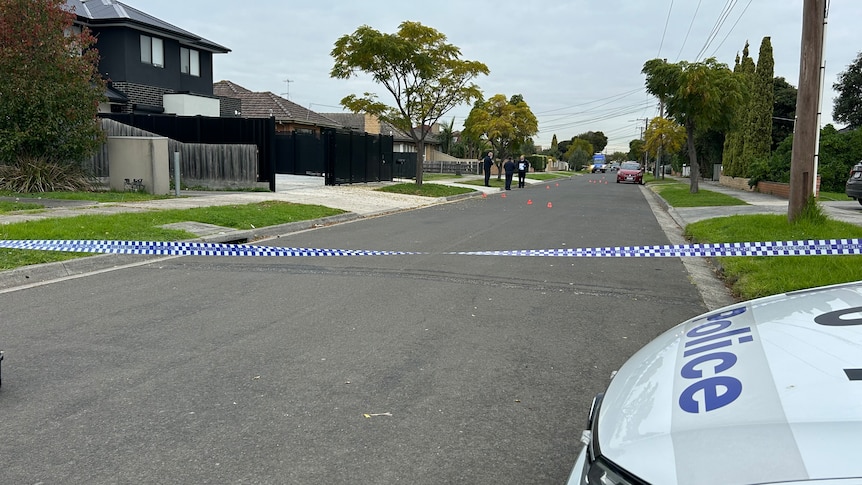 A suburban street cordoned off by police