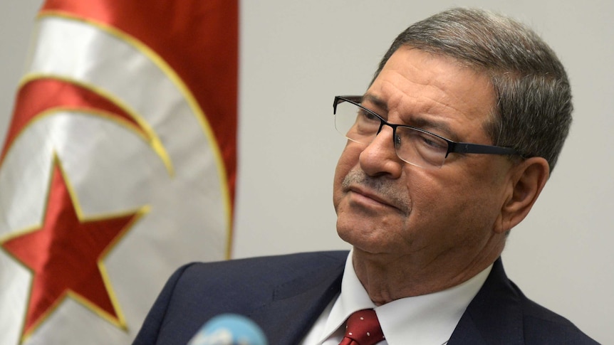 Tunisian Prime Minister Habib Essid delivers a speech.