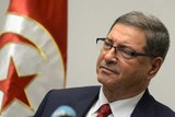 Tunisian Prime Minister Habib Essid delivers a speech.