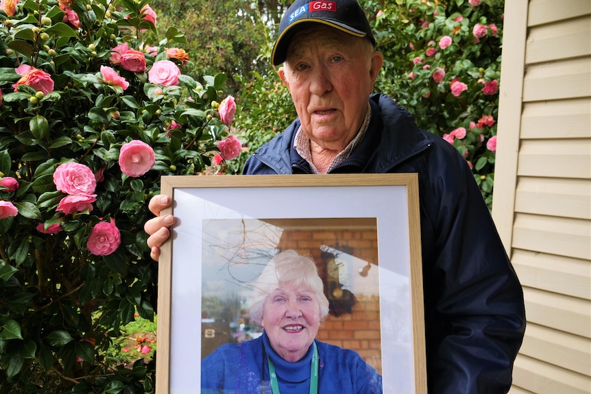Jimmy Thomson holds a photo of his wife.