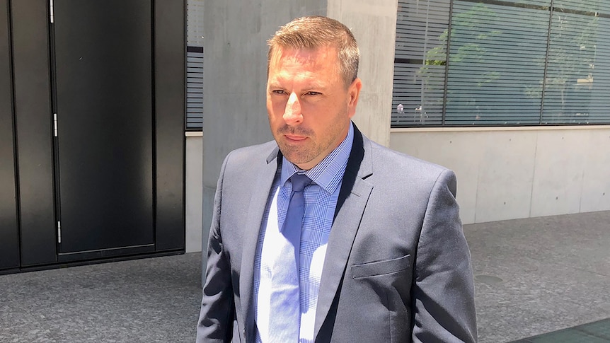 James Colin Burnham walks outside the Supreme Court in Brisbane wearing a suit on November 26, 2019