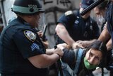 Police detain a protester during a solidarity rally for George Floyd, Saturday, May 30, 2020, in New York