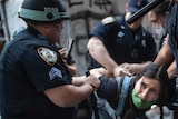 Police detain a protester during a solidarity rally for George Floyd, Saturday, May 30, 2020, in New York