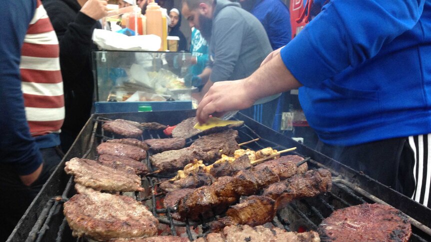 Camel burger patties are cooked at the Ramadan food festival in Lakemba