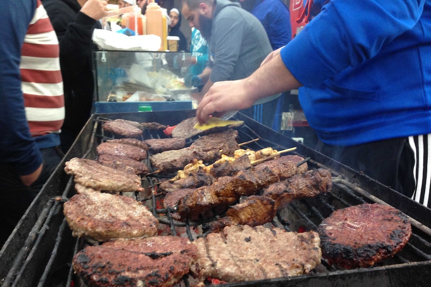 Camel burger patties are cooked at the Ramadan food festival in Lakemba