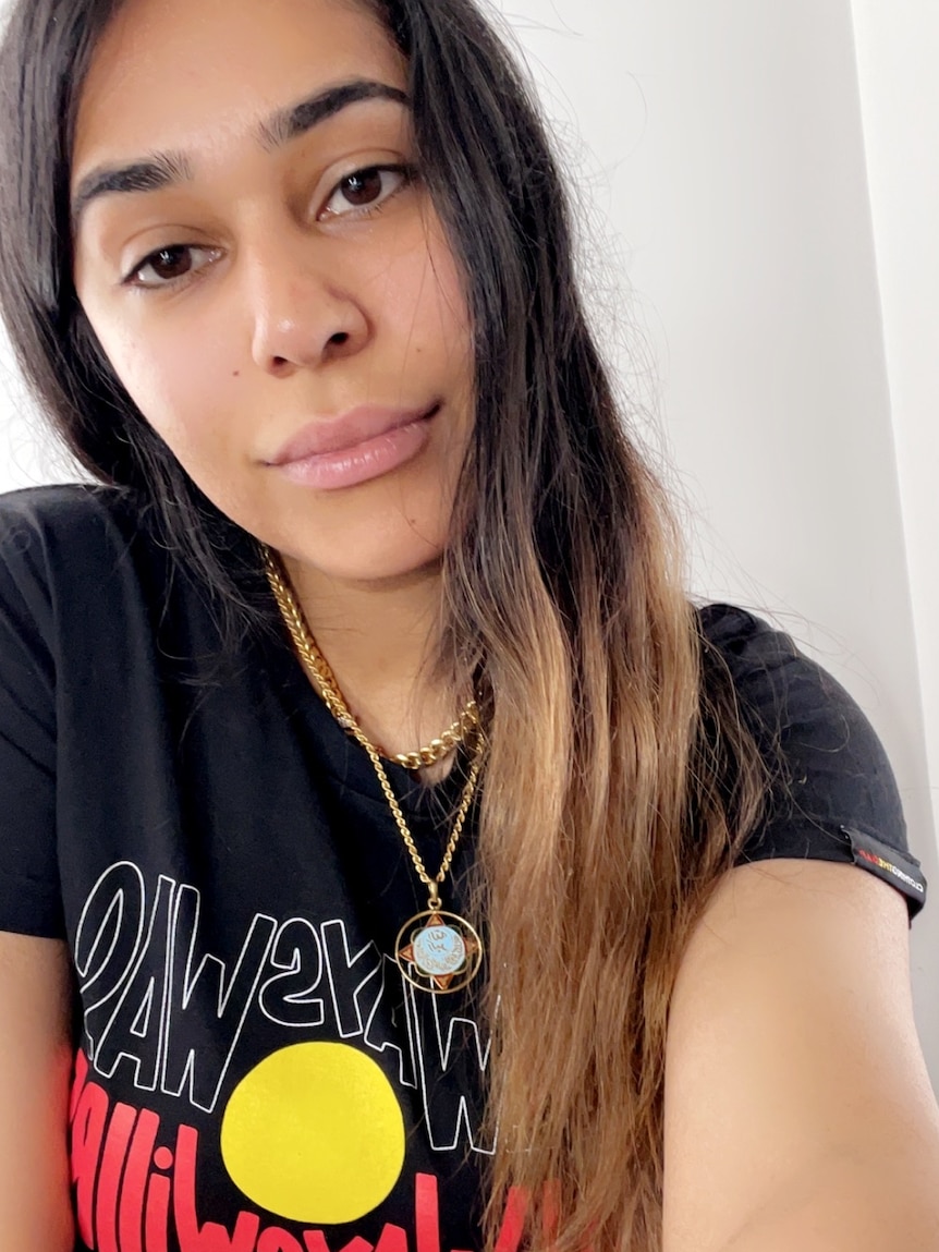 A photo of Shahnaz Rind wearing a t-shirt with an Aboriginal flag. 