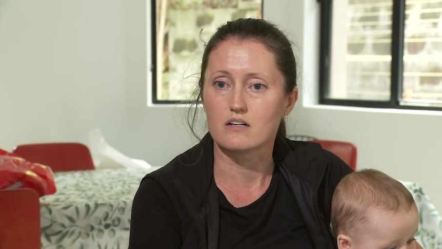 Christina Bullivant, a woman with dark hair, looks at the camera during an interview.