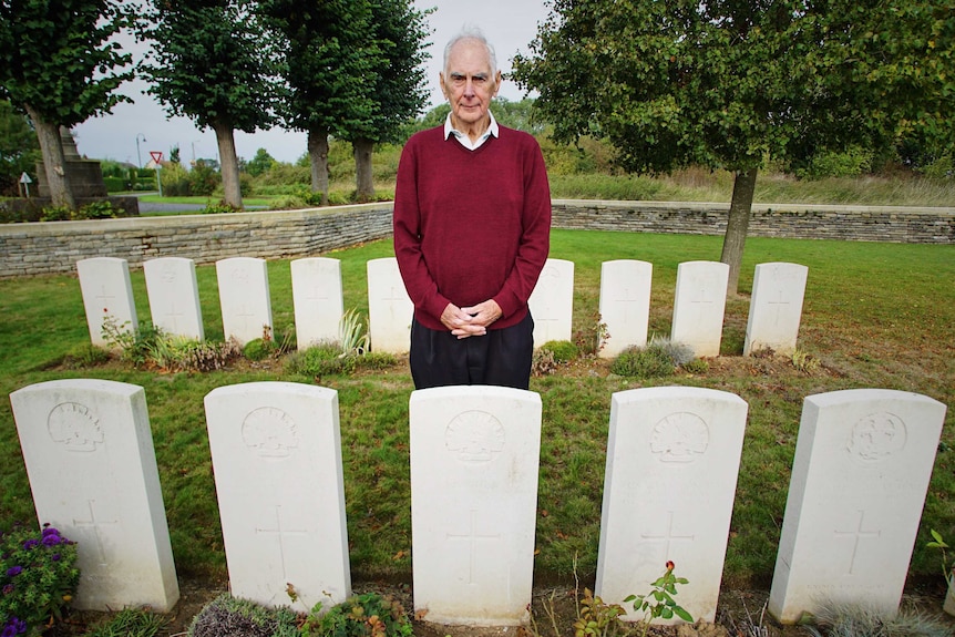 John Devitt standing behind Cecil Healy's grave in France