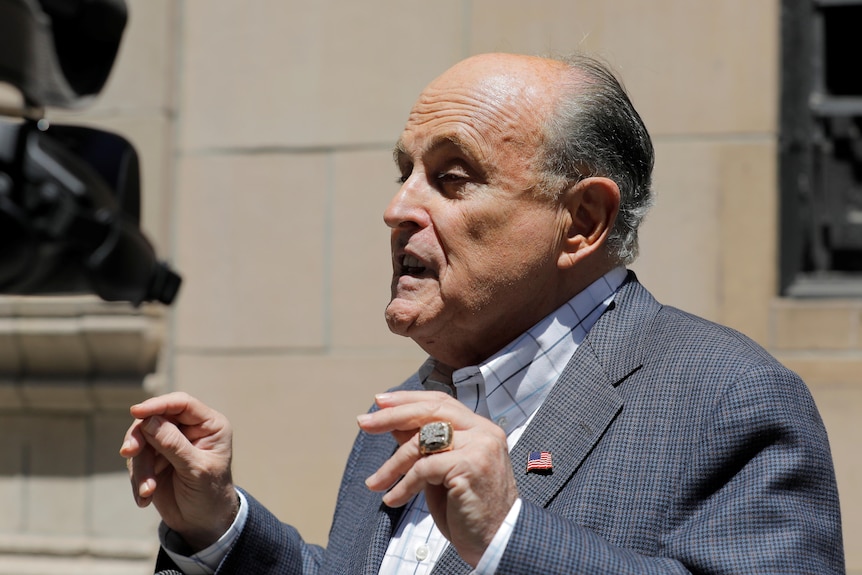 Rudy Giuliani addresses the press outside his apartment building after his NYC law license was suspended