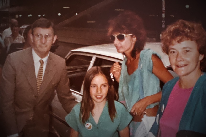 A young Claudia Karvan with her mother and two other adults getting out of a white car at the Molly preview.