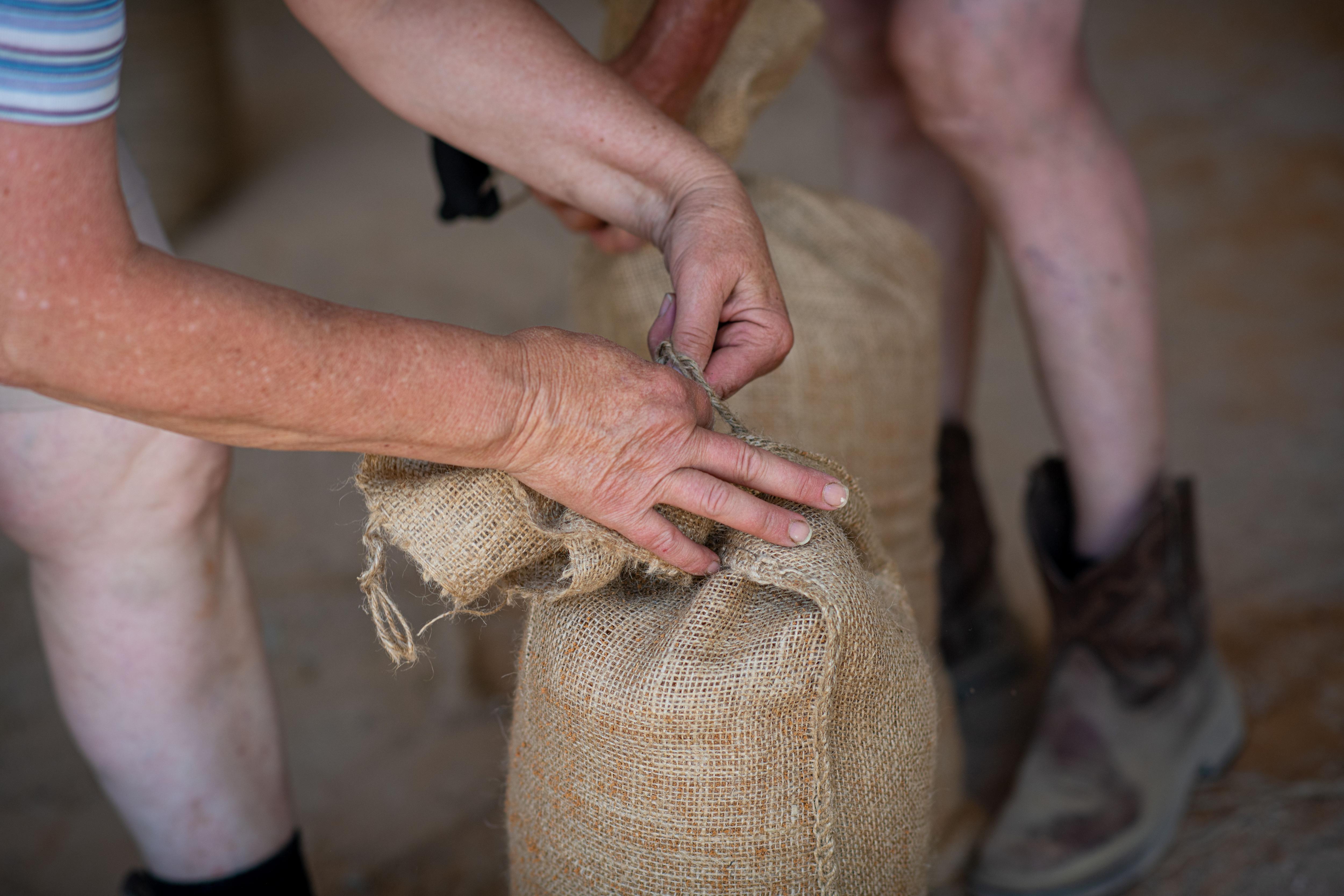 Residents at Riverglen near Murray Bridge fill sandbags.