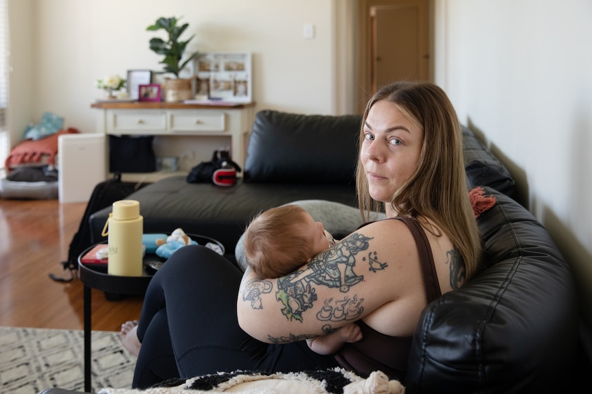 Sarah on couch holding bub