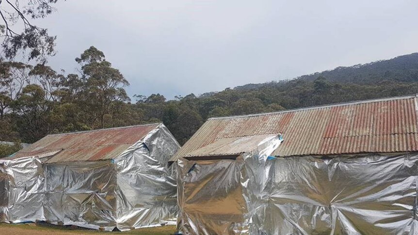 Mountain huts wrapped in foil to prevent ember attack