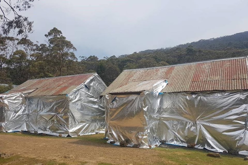 Mountain huts wrapped in foil to prevent ember attack