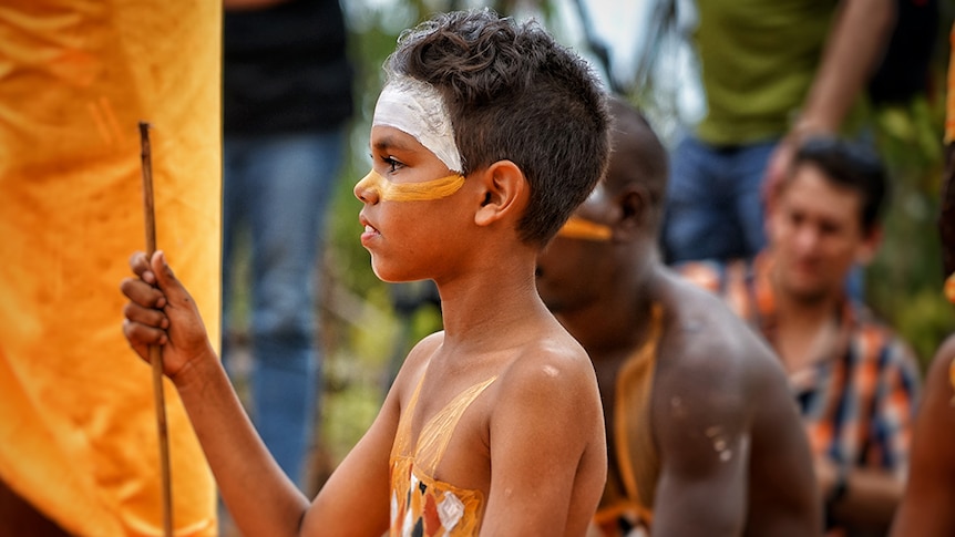 A young child participates in the opening ceremony of the 2017 Garma Festival.