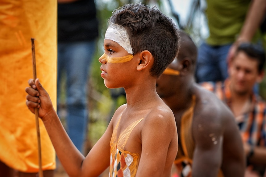 A young child participates in the opening ceremony of the 2017 Garma Festival.