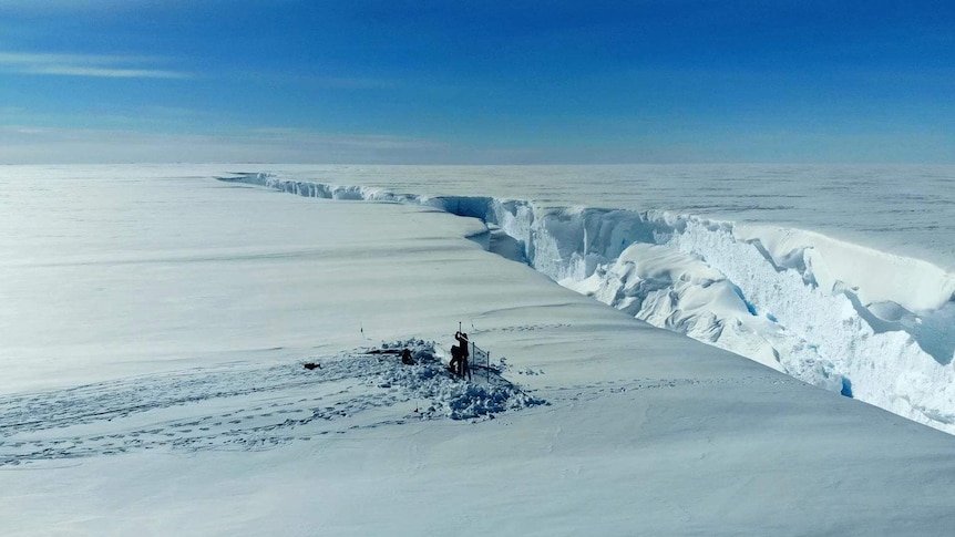 Researchers set up equipment in front of a huge crack on the Brunt Ice Shelf in Antarctica.