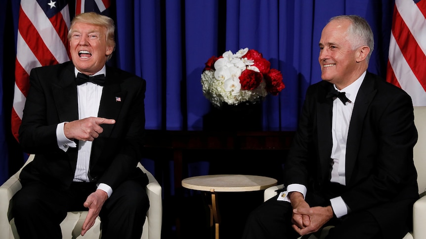 Donald Trump laughs and points towards Malcolm Turnbull during a meeting ahead of Coral Sea 75th anniversary commemorations.