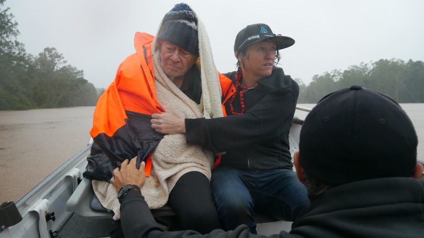 Dr Jim Gallagher being rescued in a boat during the peak of the floods.