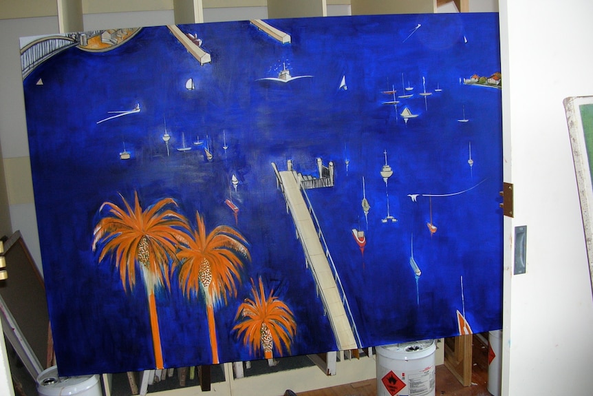 A shot from above of a blue painting in progress of a harbour with palm trees that have been painted orange