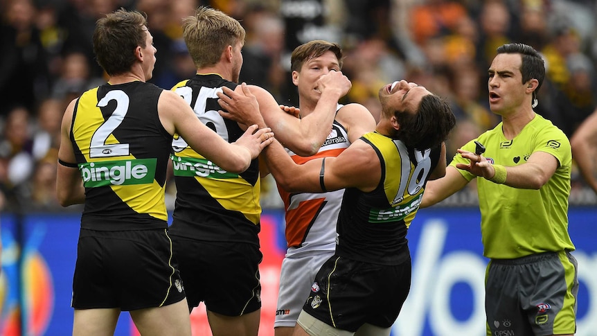 Toby Greene (third L) of the Giants and Alex Rance of the Tigers wrestle at the MCG.