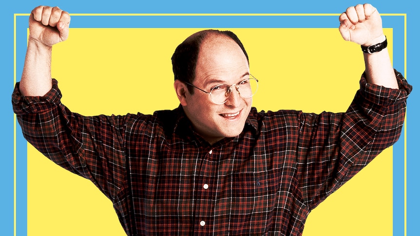 'Costanza' raises his fists and smiles while standing awkwardly