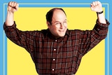 'Costanza' raises his fists and smiles while standing awkwardly