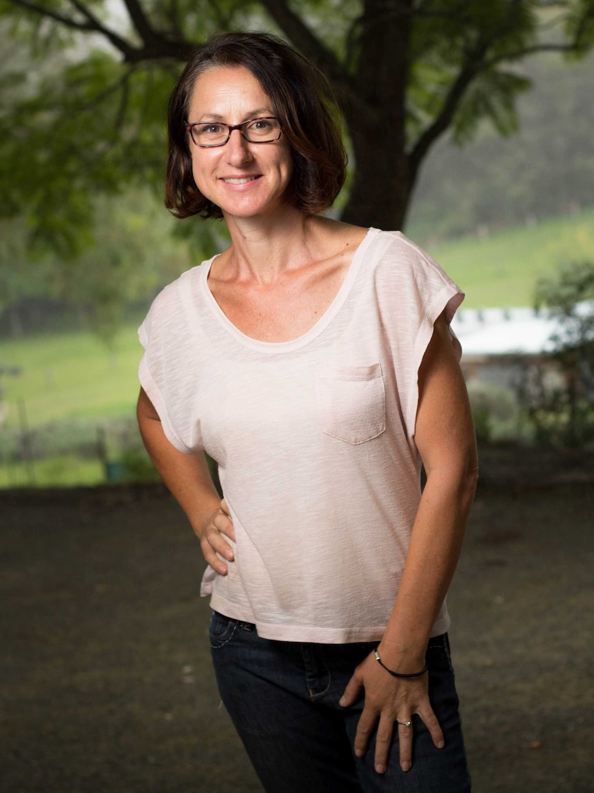 Daniela Riccio stands on a veranda.