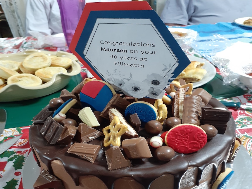 A chocolate cake with a congratulatory sign on top 