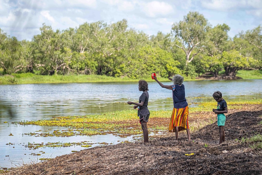 A family fishes at Magela Creek in Kakadu National Park