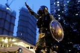 A riot police officer gestures during a demonstration held by anti-extradition bill protesters in Tai Wai