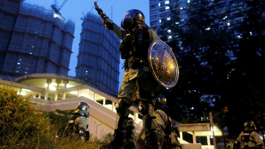 A riot police officer gestures during a demonstration held by anti-extradition bill protesters in Tai Wai