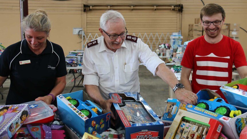 Cheryl Tollis, Neil Dickson and Jared Proellocks from the Salvation Army sorting toys
