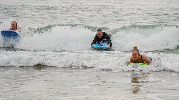 Group of elderly women on boogie boards on water