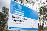 A roadside sign for Australian Government's Building our Future at the Western Sydney Airport Site.