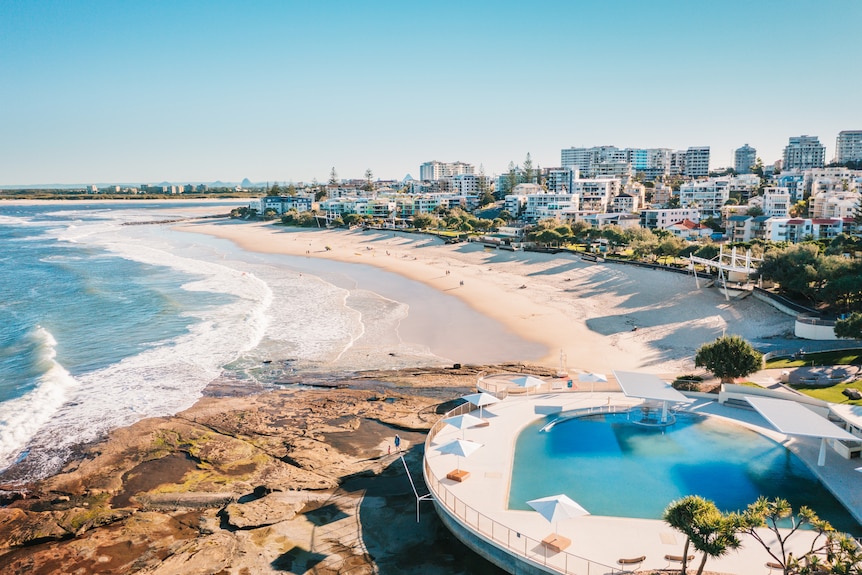 Aerial view of beachside pool, beach and ocean