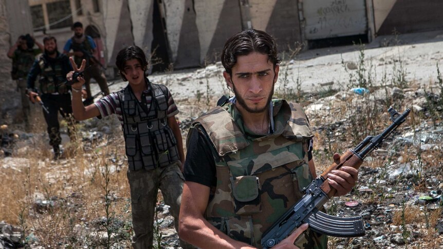 Syrian rebel fighters belonging to the Martyrs of Maaret al-Numan battalion leave their position.