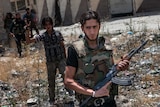 Syrian rebel fighters belonging to the Martyrs of Maaret al-Numan battalion leave their position.