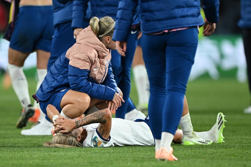 An England Lionesses player lies on the ground after England beat Colombia 2-1 in the Women's World Cup quarterfinal.