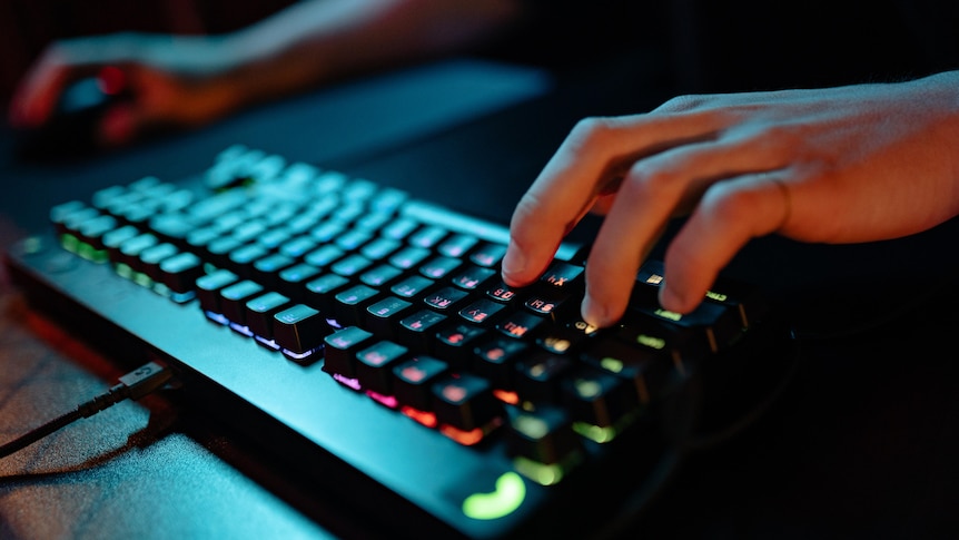 Hands using a computer mouse and keyboard