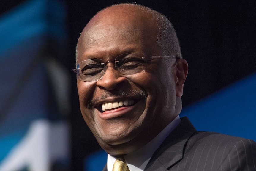 Herman Cain smiles for the camera.