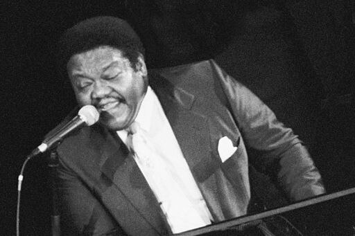 Black and white photo of fats domino at a piano
