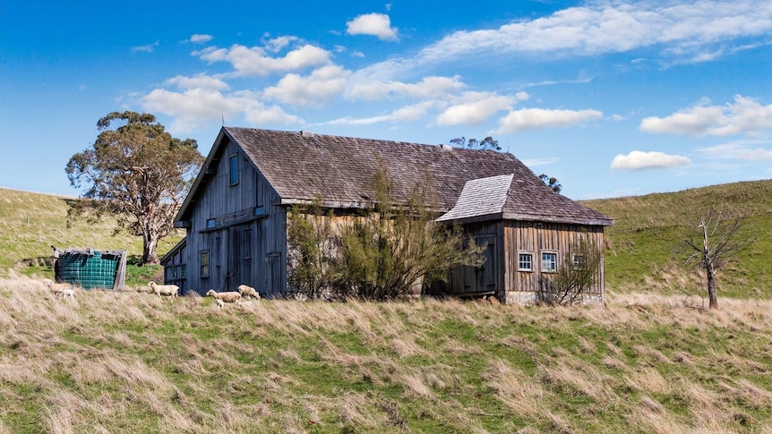 A medium sized barn on a hill