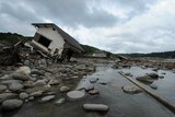 A collapsed house lies in the Hoshino River in Yame City, Fukuoka