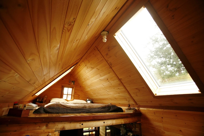 A compact bedroom in a tiny house.