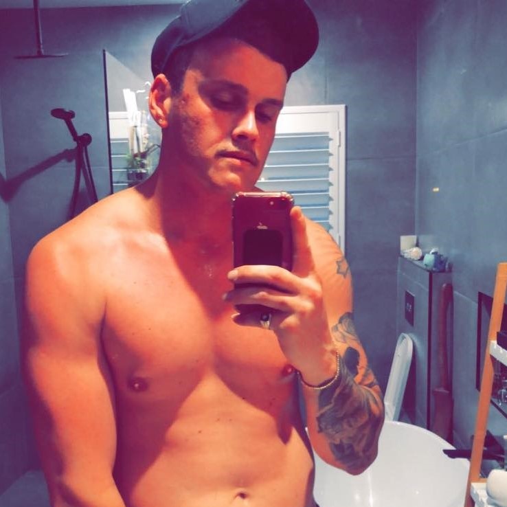Andrew Julian Stewart-Smith takes a mirror selfie with his shirt off