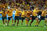 Socceroos players celebrate their win over Uruguay to qualify for the 2006 World Cup